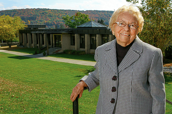 Mary Huntington in front of the Huntington Adminstration building