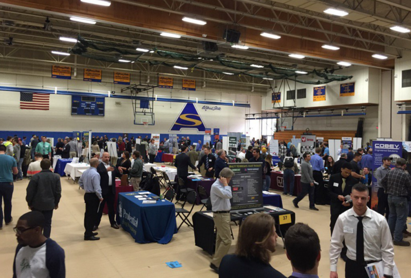 students and employers and tables set up in the gymnasium