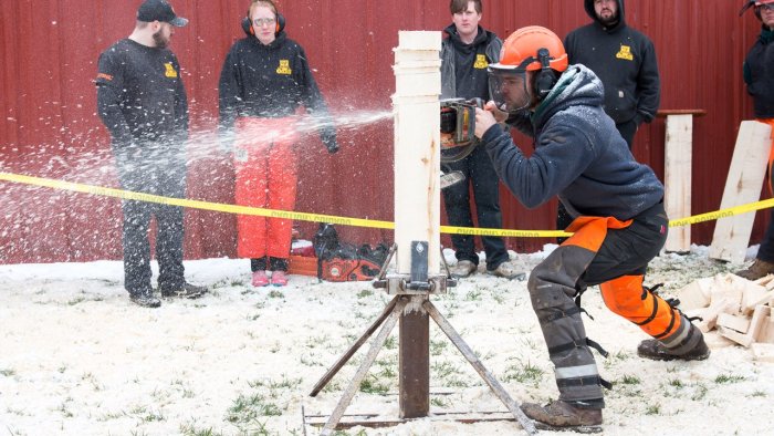 student competes in a timber sports event